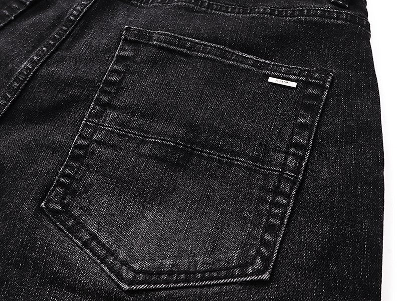 AMIRI Varsity Letter Appliqué Distressed Jeans — detail